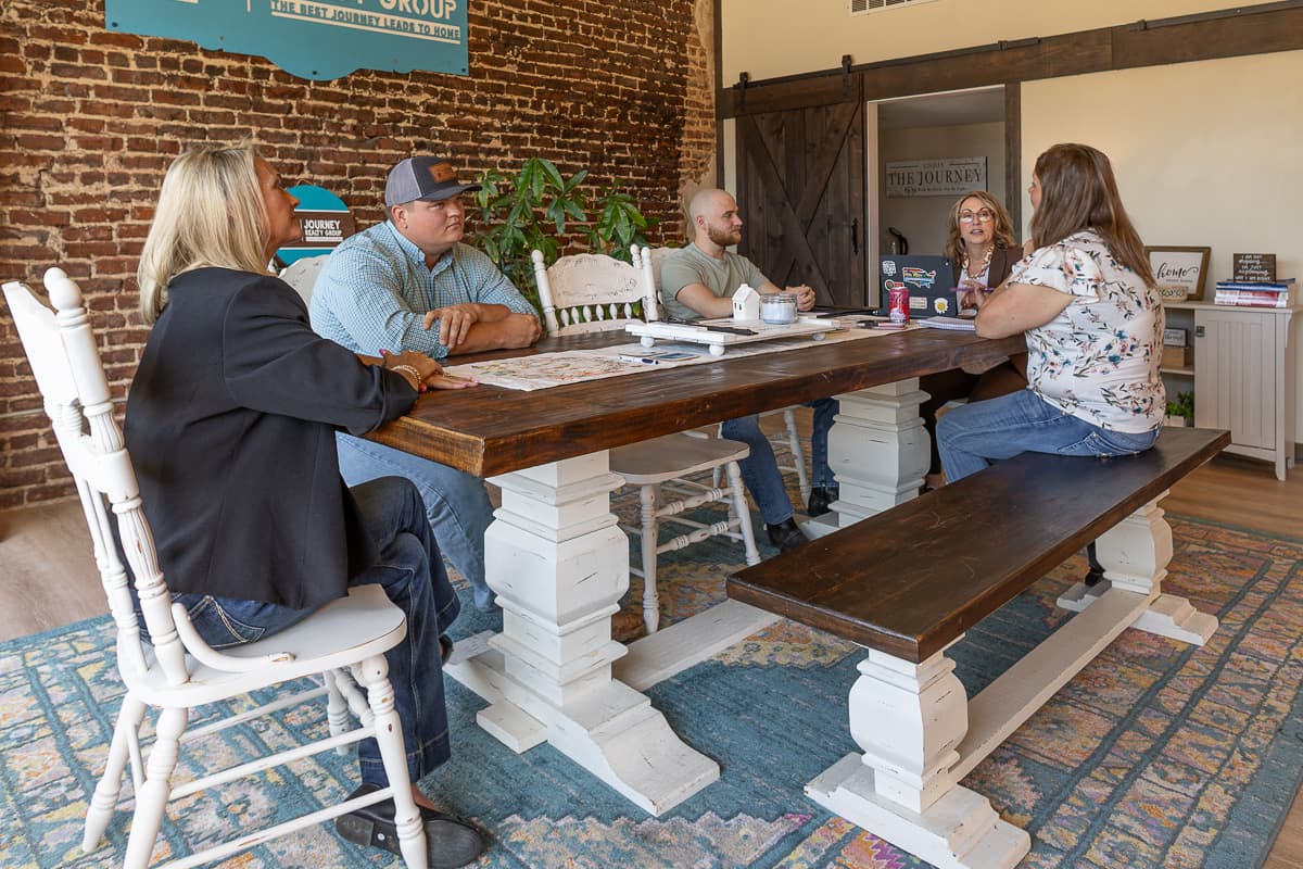 Journey Realty Group Team Working At Conference Table